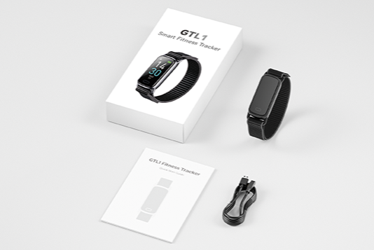 GTL1 in the box: packaging, manual, magnetic charging cable, and fitness tracker.